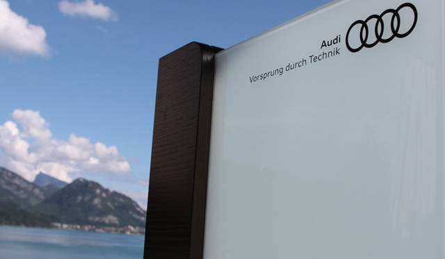 <strong>Audi</strong> – The logo mark, set by the hotel's lakeside