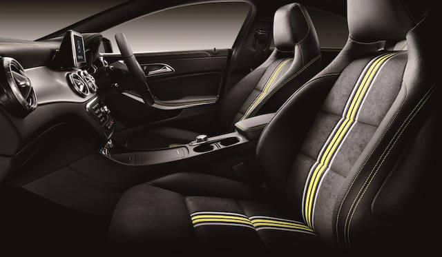 The Edition 1 interior features integrated sports seats with striking yellow and gray stripes, called "NEON ART." The yellow stitching on the leather ARTICO dashboard and armrests further enhances the contrast between black and yellow.