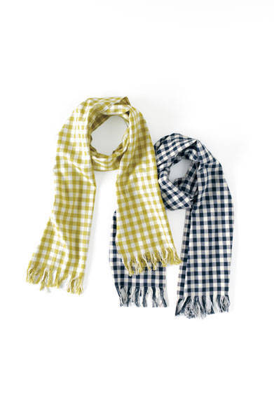 The 100% silk scarf, finished by hand with an original pattern, has a distinctive voluminous quality. A contrasting highlight color along the side, reminiscent of denim selvedge, adds an accent. Scarves ¥38,880 each (Margaret Howell)