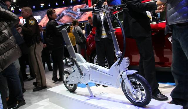 Ford's "MoDe:Me" on-board electric assist cycle. The linked smartphone app suggests the optimal combination of bicycle, car, and bus to reach your destination.