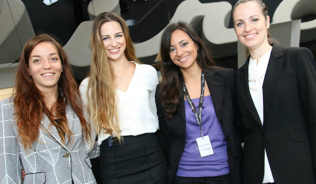 Female staff members greeting visitors at the entrance.