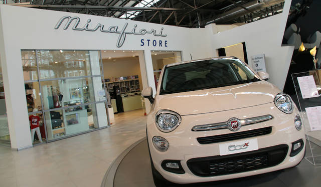 Fiat 500X displayed in front of the official merchandising shop.