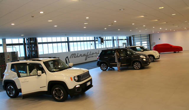 Delivery area. New cars are picked up one after another.