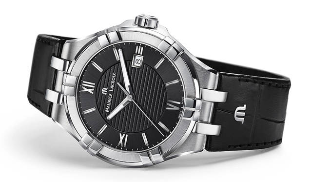 The twin-block design on the bezel and lugs is eye-catching, lending the case depth and a play of light and shadow. The strap features the initial “m,” a revival design that echoes details from the brand’s early days.