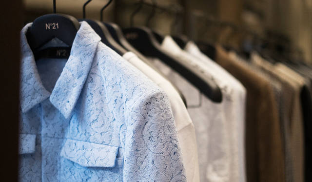 In the foreground, a men's blouson from the Spring/Summer 2015 collection, made with double lace. This is a representative item that expresses the brand's signature couture-like design.