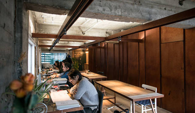 Interior featuring exposed concrete walls and intersecting H-beams