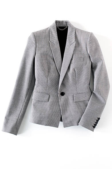 <strong>WOMENS | </strong> This micro-houndstooth tailored jacket, with its peak lapels and concaved shoulders, reflects the collection's mood. Wear it with a handsome, sharp aesthetic. Tailored Jacket ¥82,080 (DIESEL BLACK GOLD)
