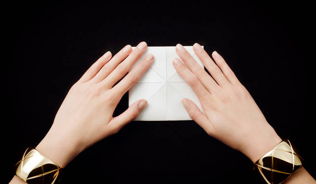 Mademoiselle Chanel often paired large cuffs on both wrists.
