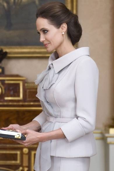 <strong>Angelina Jolie</strong><br /><br />On Friday, October 10th, actress Angelina Jolie met with Queen Elizabeth at Buckingham Palace in the UK. She was awarded an honorary Dame Commander of the Order of St Michael and St George (DCMG) in recognition of her active promotion of efforts to eradicate sexual violence in conflict zones. For the investiture ceremony, she elegantly wore a grayish-purple skirt suit by British couturier RALPH & RUSSO.