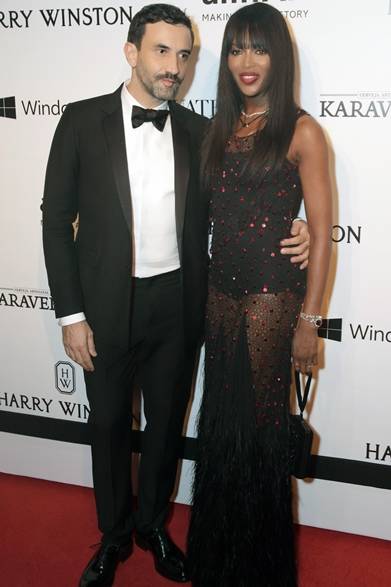We also caught a photo of Naomi Campbell and Riccardo Tisci together at the same 'amfAR Inspiration Gala.' The black sheer dress, adorned with red sequins, was a couture piece by Givenchy designed by Riccardo Tisci. Flowing black fringe down to the hem added a sensual detail.