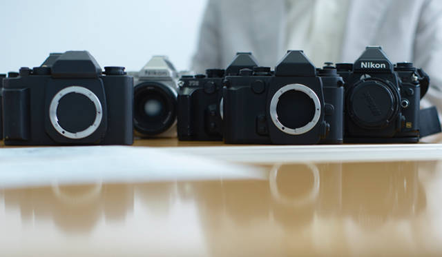 The two cameras in the foreground are mock-ups (wooden models) of the Nikon "Df"