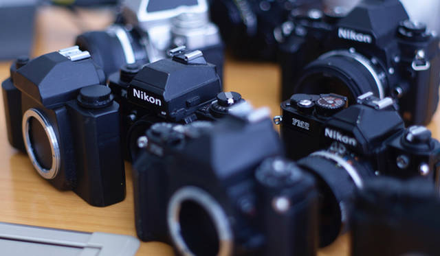 Mock-ups (wooden models) and film cameras such as the Nikon "F series," which served as design references during development.