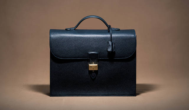 A classic briefcase from MAURO GOVERNA, crafted from taurillon leather dyed an indigo blue called Partico. ¥248,400 (JACKET REQUIRED)