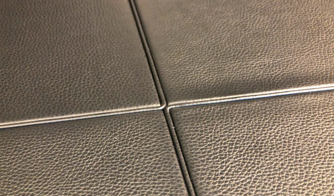 Tabletop crafted from four refined leather panels.